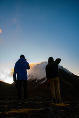 Obraz premium silhouette of a man and a person on a mountain top