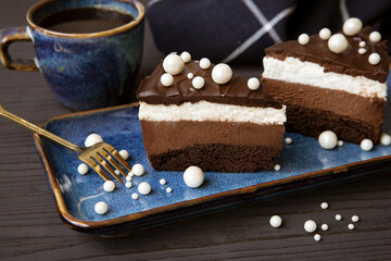 A cup of fragrant coffee and a cake on the table in a beautiful dish.