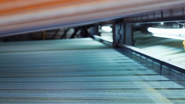 Carpet factory, carpet production, synthetic colorful yarns for weaving looms. abstract background. Yarn thread lines on the weaving loom machine in textile factory. 4K