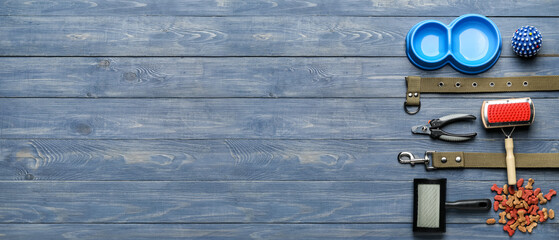 Different pet accessories on wooden background with space for text, top view