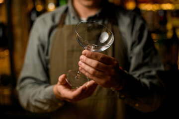 Selective focus on clean transparent empty wine glass in caucasian male hands