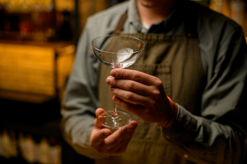 close-up of caucasian male hands gently holding clean transparent empty wine glass