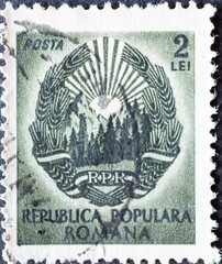 Romania - Circa 1949: A Postage Stamp from Romania, Showing Sun, Grain Spikes, Forest. The coat of arms of Romania around 1949.