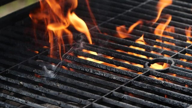 Close-up barbecue grill, slow motion night burning fire flame, cooking outdoors