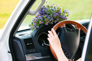 Naklejka premium Bouquet of wildflowers on a dashboard of a car