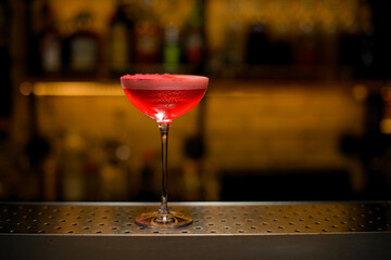Selective focus on wine glass full of signature cocktail with tomato juice