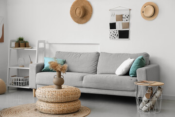 Interior of cozy living room with rattan poufs and sofa