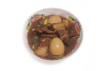 Stewed eggs with pork belly in a white bowl.