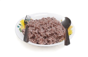 purple rice on a white plate with a pair of cutlery