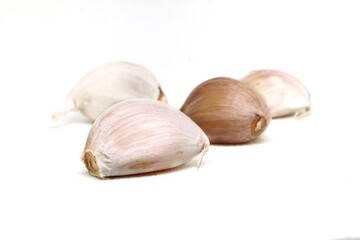 white background photo four white garlic laying in a row