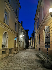 One of the narrow, cobbled streets of Old Tallinn against the blue sky. Spring evening. Wanalynn area.