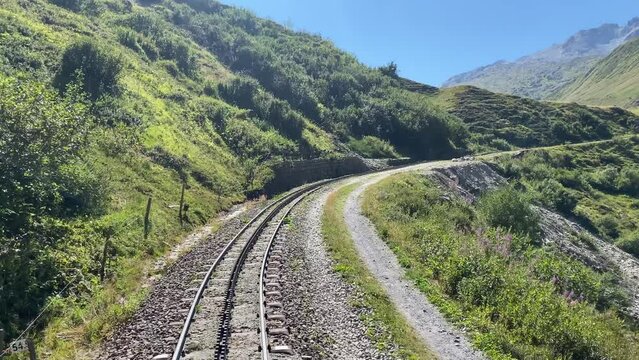An old cog railroad runs over the mountains in Switzerland. The steam locomotive reminds of the old times. Pure nostalgia