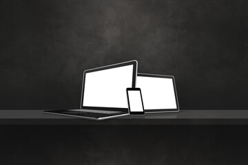 Laptop, mobile phone and digital tablet pc on black wall shelf. Horizontal background