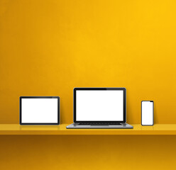 Laptop, mobile phone and digital tablet pc on yellow wall shelf. Square background