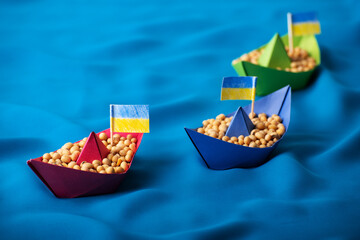 Boats with Ukrainian soybeans made of paper origami concept