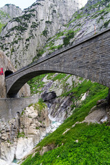 Famous Devil's Bridge at Schöllenen Gorge, Canton Uri, on a sunny summer day. Photo taken July...
