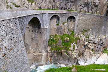 Famous Devil's Bridge at Schöllenen Gorge, Canton Uri, on a sunny summer day. Photo taken July...