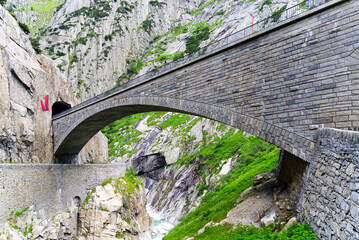 Famous Devil's Bridge at Schöllenen Gorge, Canton Uri, on a sunny summer day. Photo taken July...