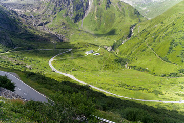 Serpentine mountain pass road of Nufenen Pass in the Swiss Alps on a sunny summer day. Photo taken July 3rd, 2022, Nufenen Pass, Switzerland.