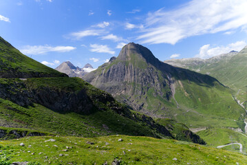 Beautiful mountain panorama seen from summt of Nufenen Pass on a sunny summer day. Photo taken July 3rd, 2022, Nufenen Pass, Switzerland.