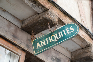 antiquites facade wall panel in city street with france text antiques in french antiquites translation means in english antiquities