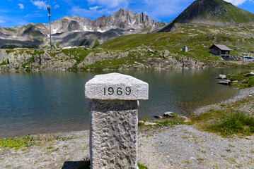 Marker stone at frontier between Canton Valais and Canton Ticino with engraved year 1969 at Nufenen...