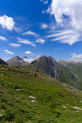 Beautiful mountain panorama seen from summt of Nufenen Pass on a sunny summer day. Photo taken July 3rd, 2022, Nufenen Pass, Switzerland.