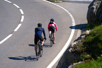 Bicycle couple on the way down form Swiss mountain pass Grimsel on a sunny summer day. Photo taken...