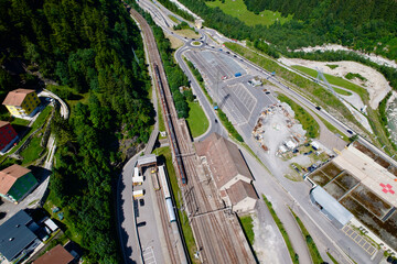 Aerial view of mountain village Göschenen, Canton Uri, with railway station on a sunny summer day....