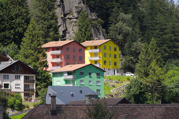 Fototapeta na wymiar Mountain village Göschenen with beautiful colored houses on as sunny summer day. Photo taken July 3rd, 2022, Göschenen, Switzerland.