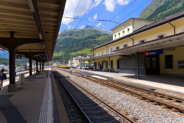 Platform at railway station of mountain village Airolo, Canton Ticino, on a sunny summer day. Photo taken July 3rd, 2022, Airolo, Switzerland.