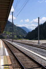 Platform at railway station of mountain village Airolo, Canton Ticino, on a sunny summer day. Photo taken July 3rd, 2022, Airolo, Switzerland.