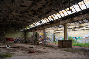 Abandoned industrial building interior. Apocalyptic scene. Ruins of large factory hangar or...
