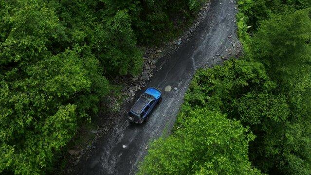 Overhead View Of Nissan Xterra Driving Across Rough Roads Of Abano Pass In Tusheti National Park, Georgia. Aerial Shot