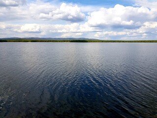 White clouds over a blue lake