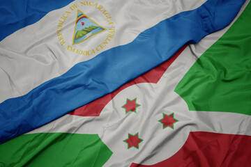 waving colorful flag of burundi and national flag of nicaragua.