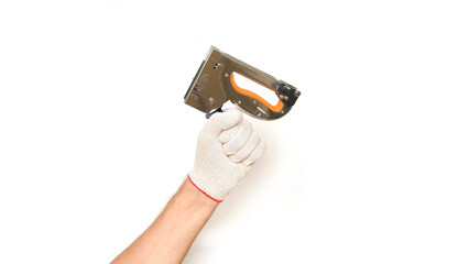 Male hand in a white glove holds a furniture stapler on a white background