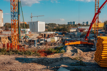 Construction of new houses. Building. Construction site. A car with concrete. Cranes.