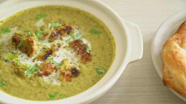 Afghani chicken in green masala curry or Hariyali tikka chicken hara masala with roti or naan bread - Indian food style