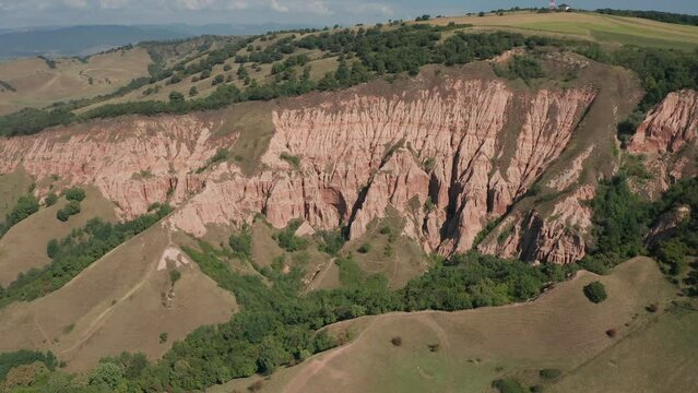 4K aerial view of Rapa Rosie mountain landmark (translated in English - Red Ravine) in Transylvania. Travel landscapes of Romania.