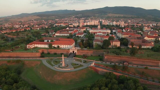 4K aerial view over the beautiful landscape of fortress Alba Carolina from Alba-Iulia city in Transylvania, during a summer sunrise. Travel to Romania.