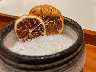 Dried oranges in bowl of bath salts close upview