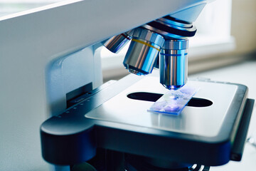 Research of test sample under medical microscope in laboratory, close-up © Peakstock