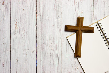 A wooden cross on wooden background with copy space. 