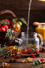 Boiling water is poured into a kettle with berries and spices