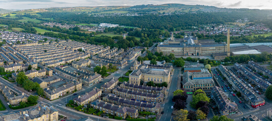 An aerial drone shot of Saltaire,the Victorian era Salt's Mill and associated residential district located by the River Aire and Leeds and Liverpool Canal is a designated UNESCO World Heritage Site an