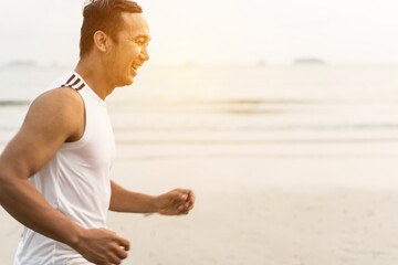asian sport man running along seaside. running on beach with healthy toned legs body, Hamstring muscles, knee joint health active lifestyle panoramic banner background. the beach runners working out