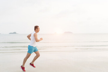 asian sport man running along seaside. running on beach with healthy toned legs body, Hamstring muscles, knee joint health active lifestyle panoramic banner background. the beach runners working out
