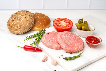 Patty of minced meat for burger. Grey background. Top view.