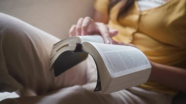 Unrecognizable Woman Reading Bible At Home. Closeup